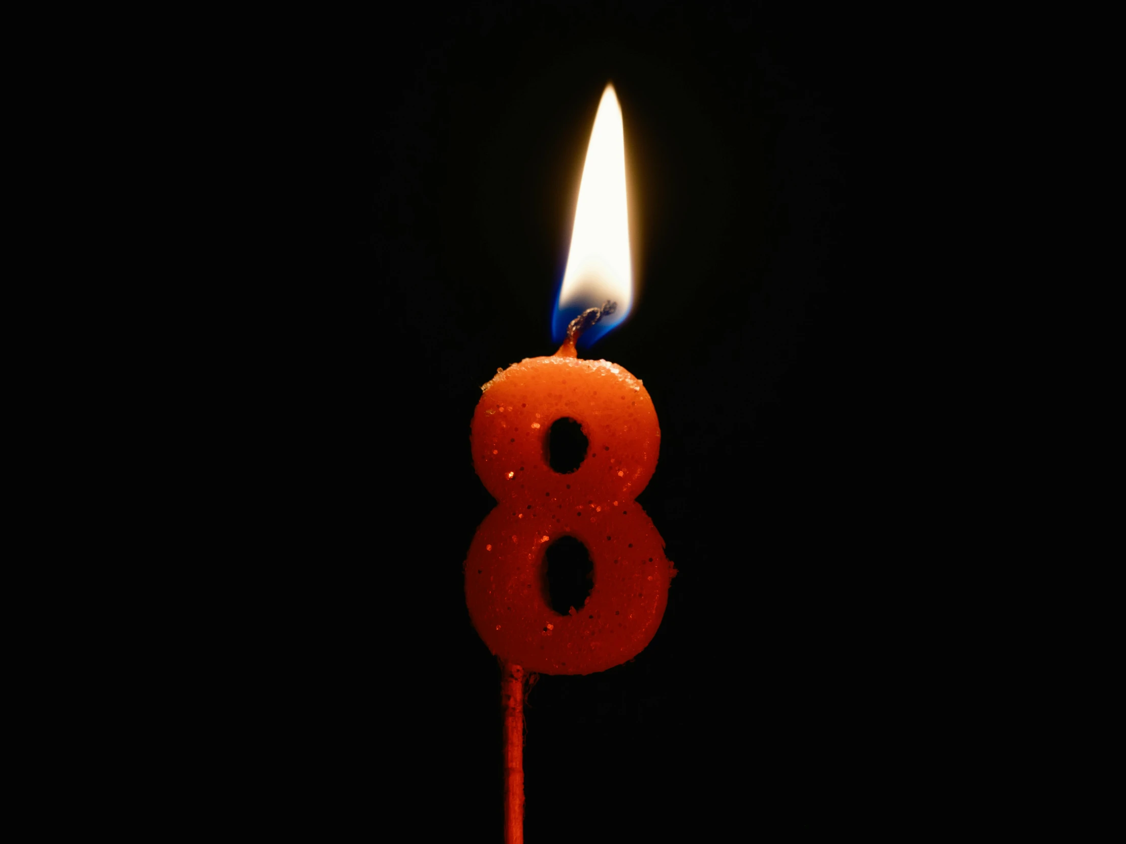 a candle that has been lit on the dark background