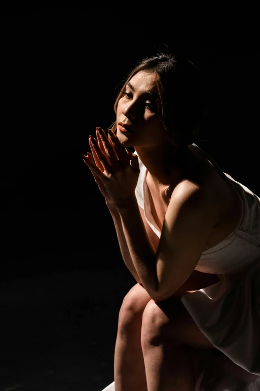 a beautiful woman sitting cross legged in prayer