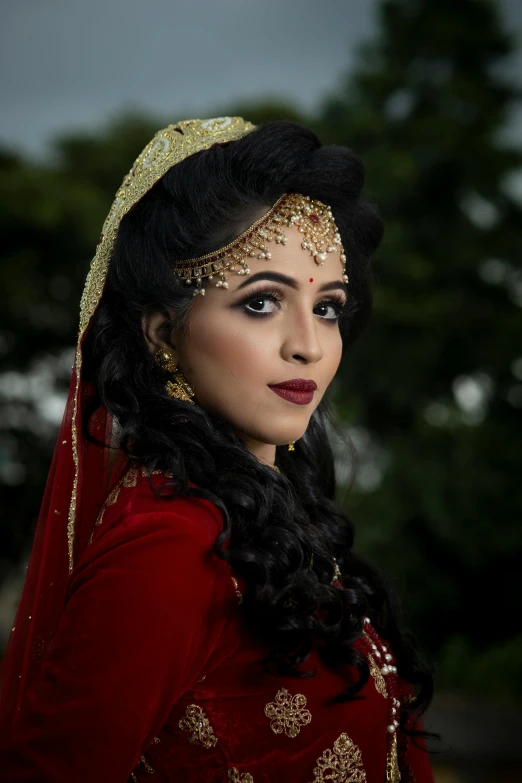 a bride with a traditional indian dress and hair comb