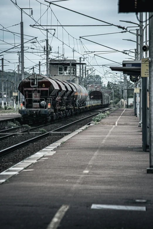 a train pulling into a train station next to a platform