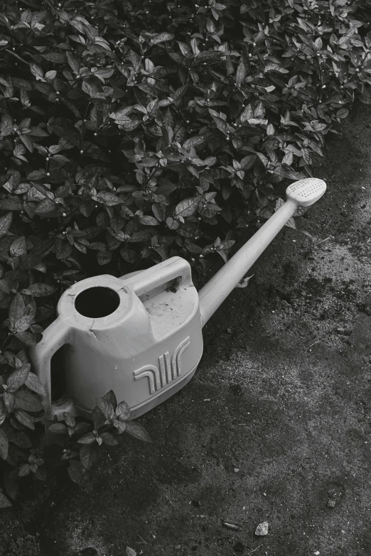 a black and white po of an old, dirty plastic hand pump