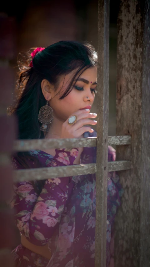 a woman looking out of the window in a purple and blue outfit