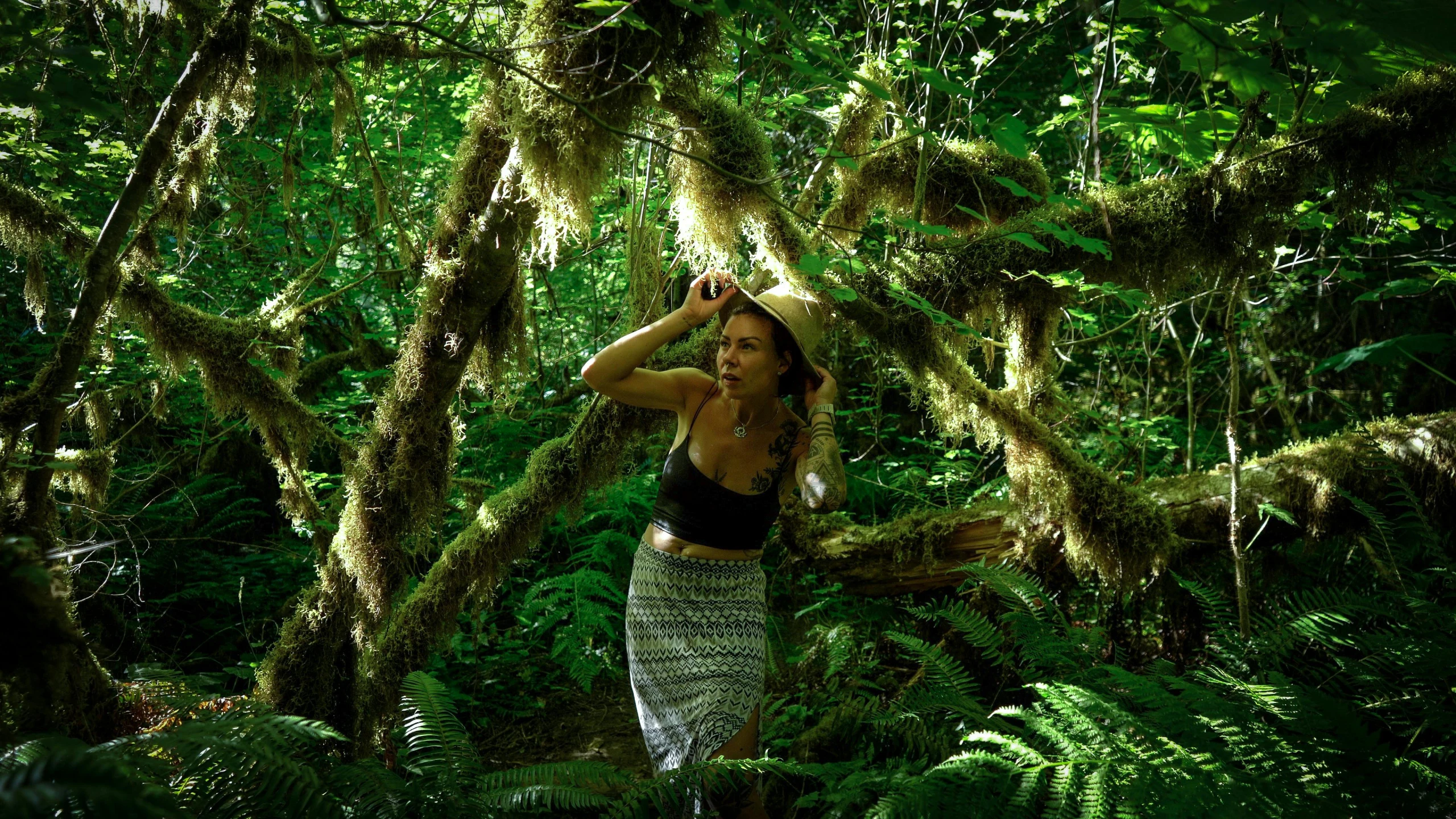 woman taking selfie in middle of forest