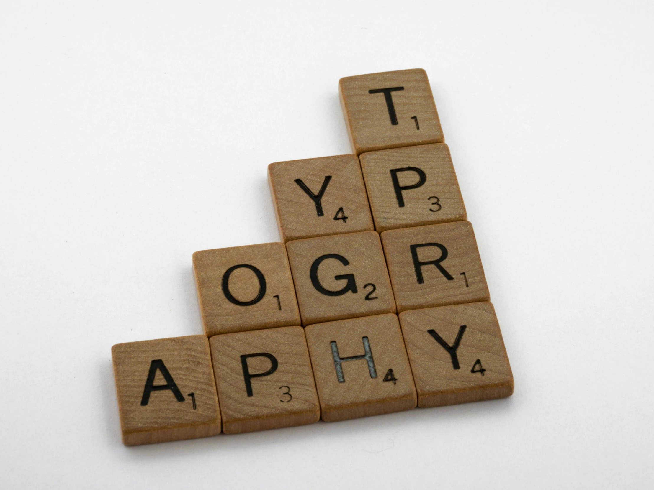 a scrabble tile pattern of letters arranged into a triangular