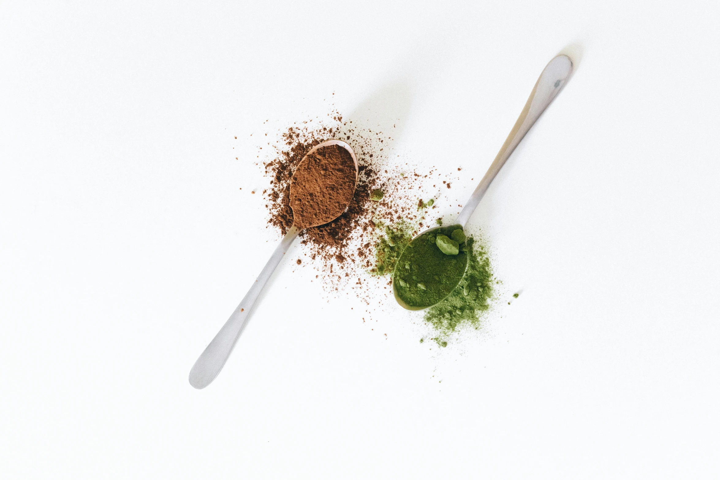 some green powder on a spoon and a white backdrop