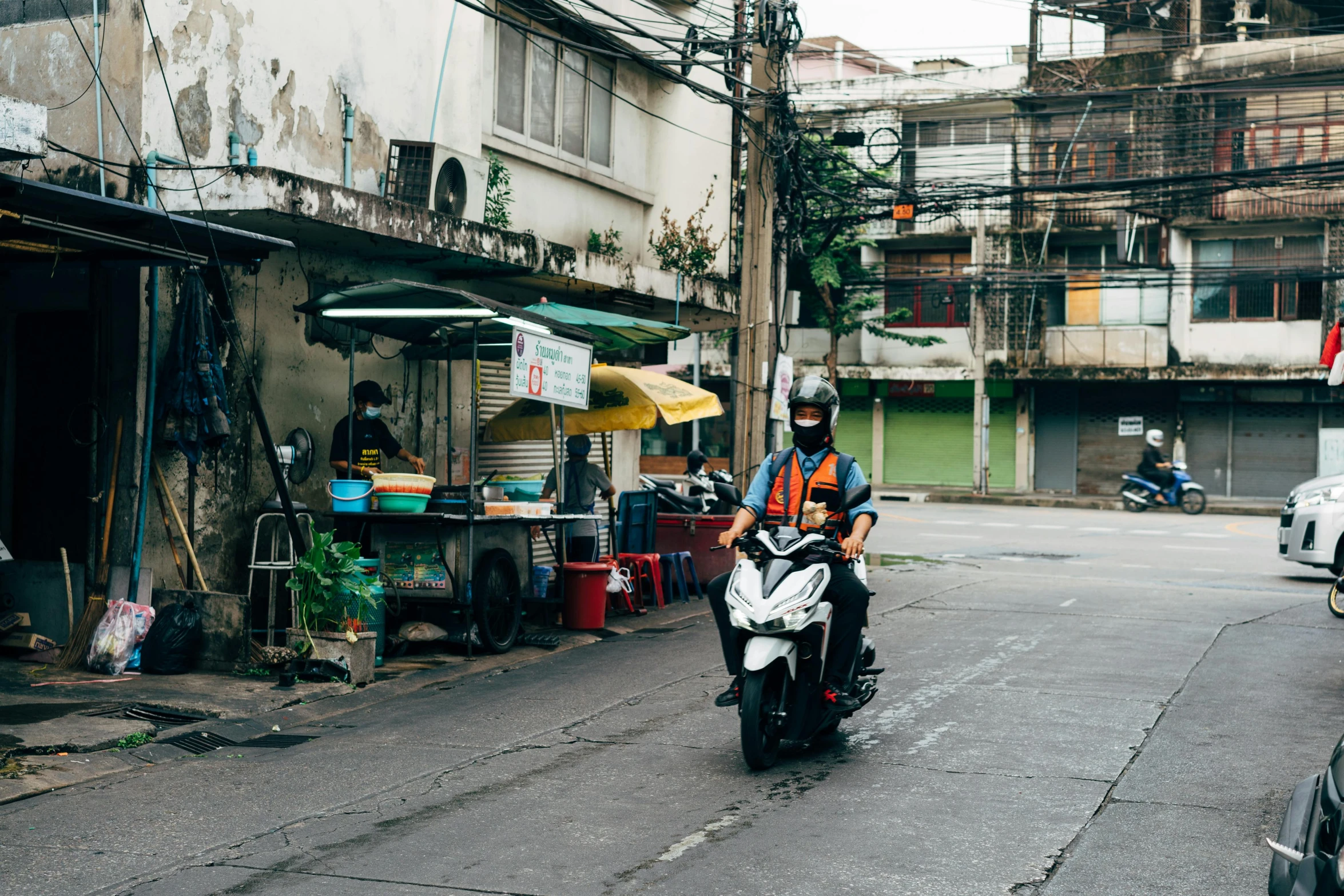 a person riding a motorcycle on an alley