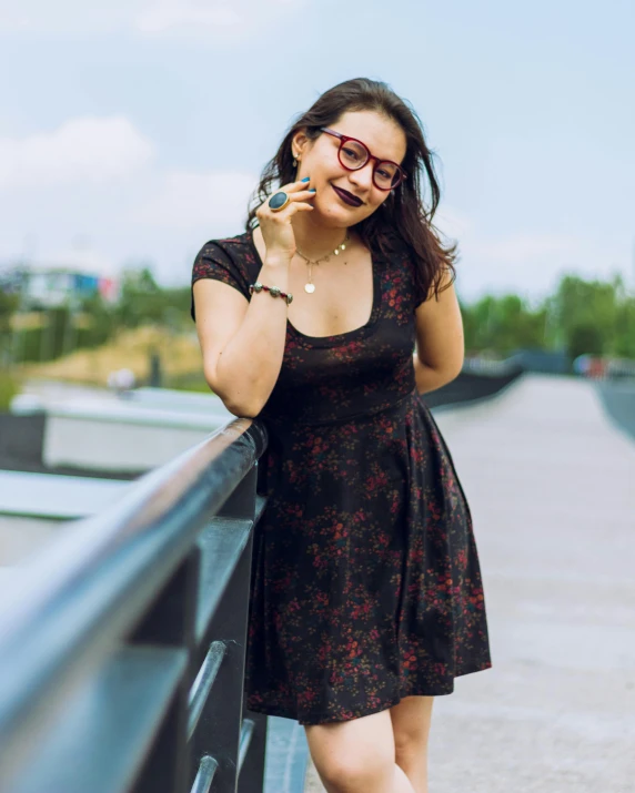 a lady that is standing up talking on the phone