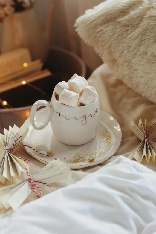 coffee in a cup and a ornament set up on a bed