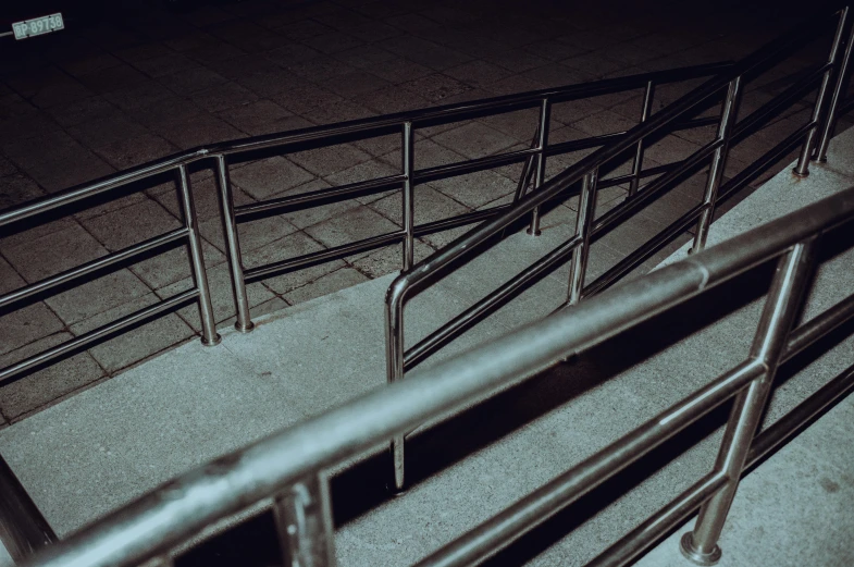 a close up view of railings on the stairs at night