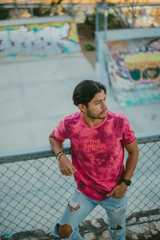 a man that is standing near a fence