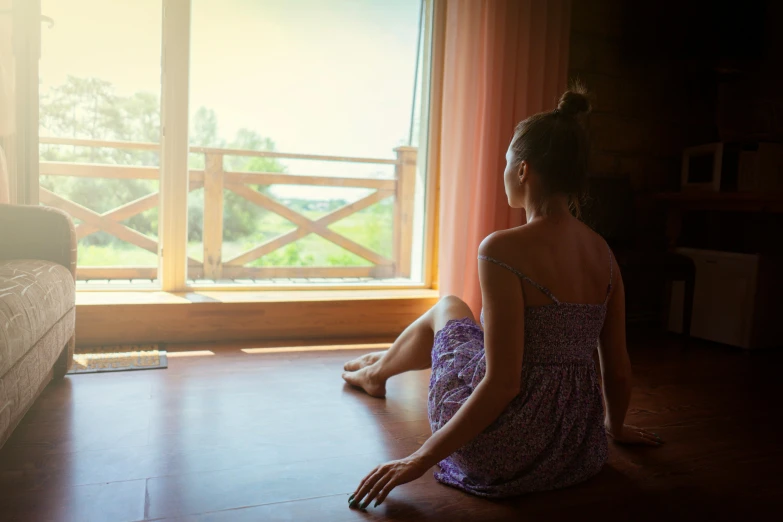 a woman sitting on the floor near a couch