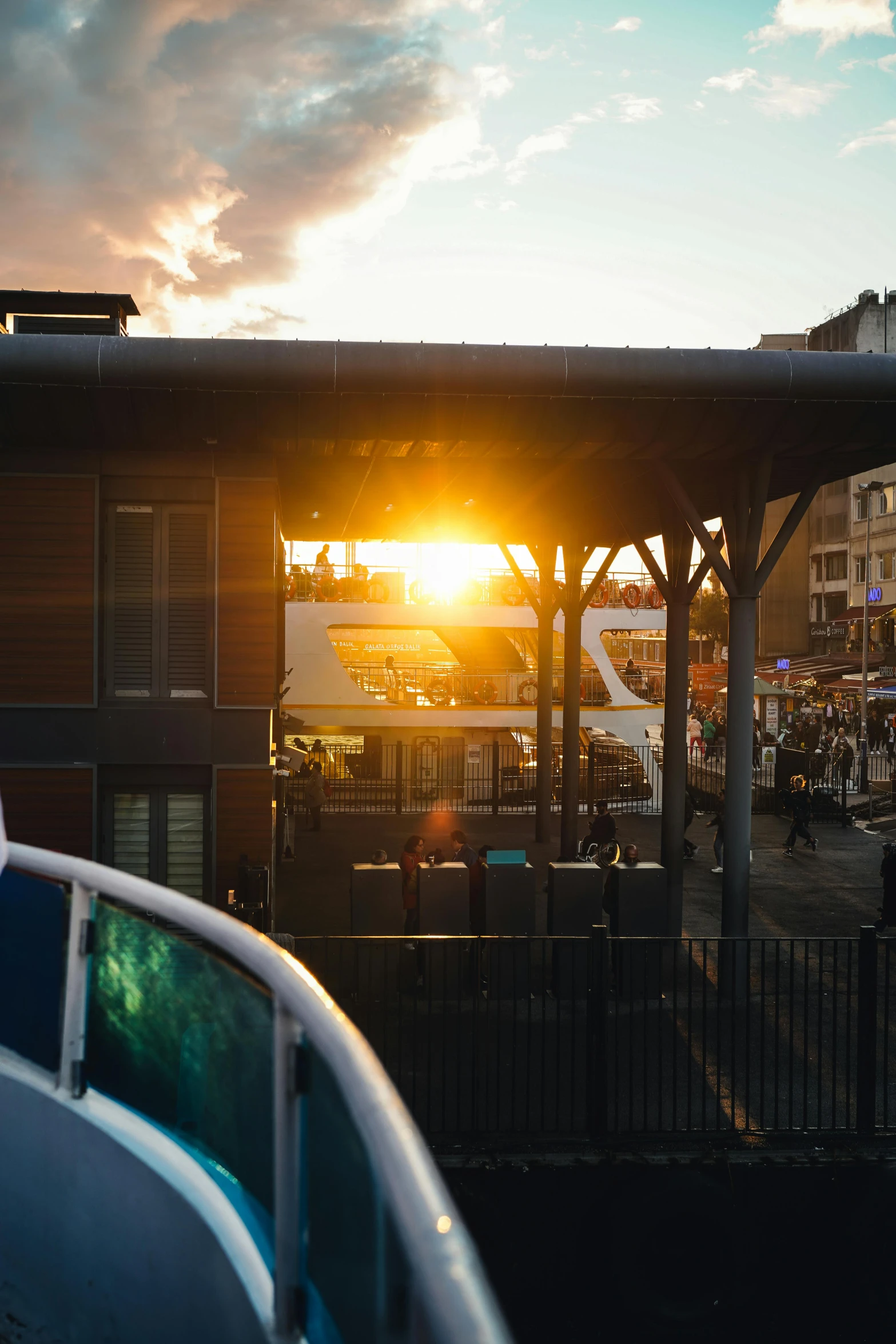 the sun rising over a parking lot in an area that looks almost rural