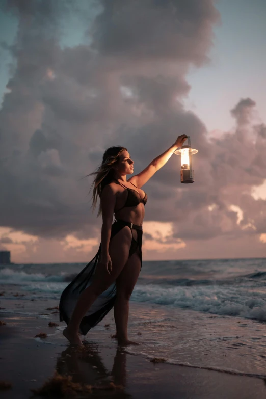 a woman in a bathing suit on the beach holding an object with one hand