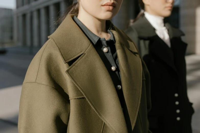 two women in coats are facing opposite directions