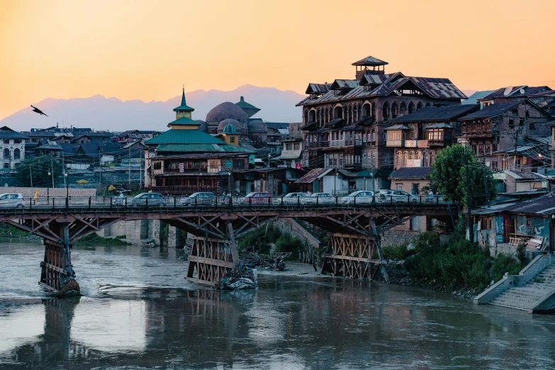 a river view of a large bridge and old buildings