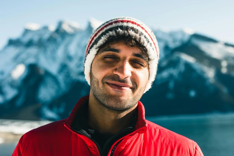 a man in a red jacket is smiling while wearing a red sweater