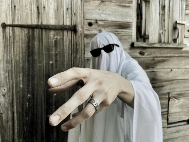 a person with a veil and a ring on their hand