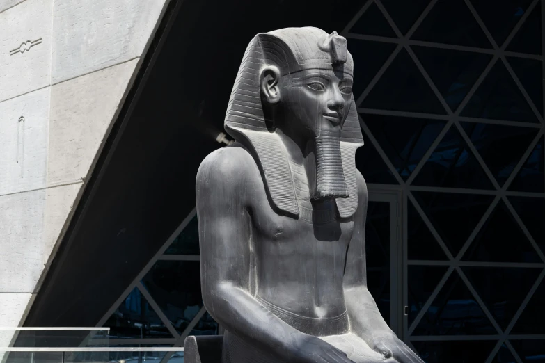 a statue sitting in front of a building