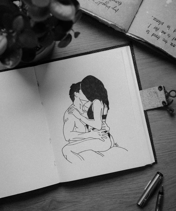 a couple's portrait is drawn on a page from a notebook