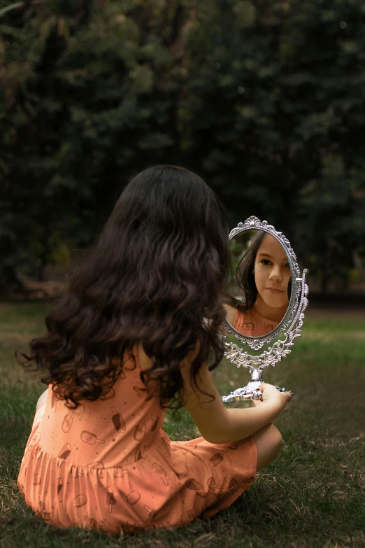 a  looking into the mirror of her reflection
