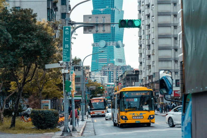 a city bus and car moving down a busy street