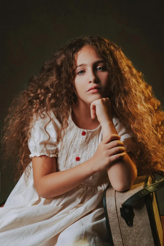 girl wearing white sitting on suitcase with red dot collar