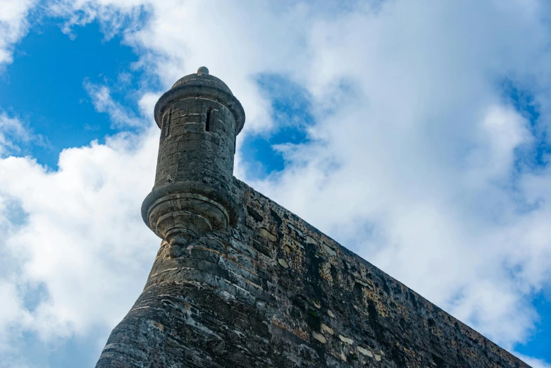 a tower structure that is under a cloudy blue sky