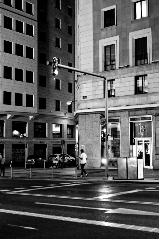 black and white pograph of people walking in a city street