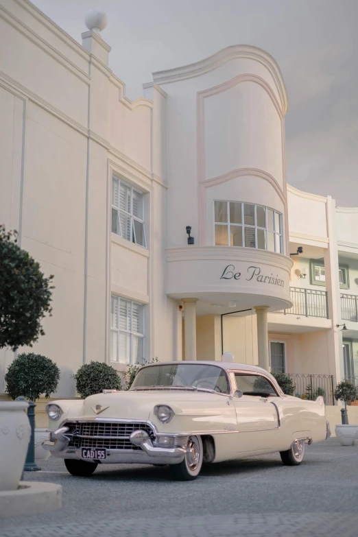 an old fashioned car in front of a building