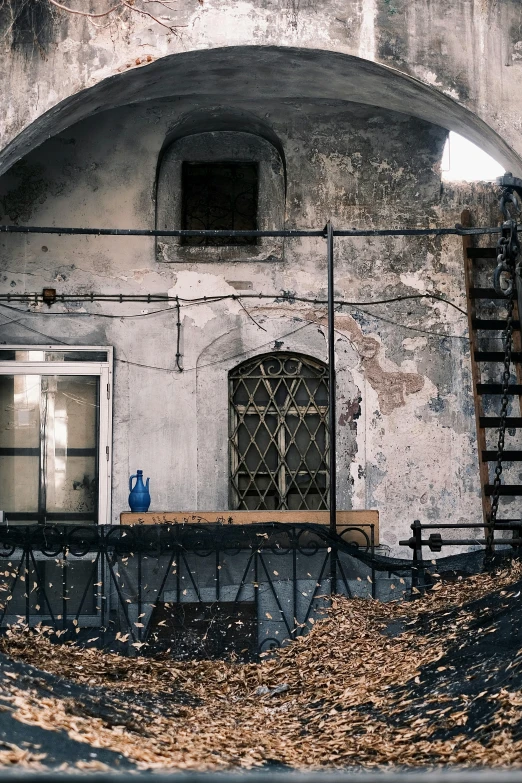 an arched doorway in an old, faded wall