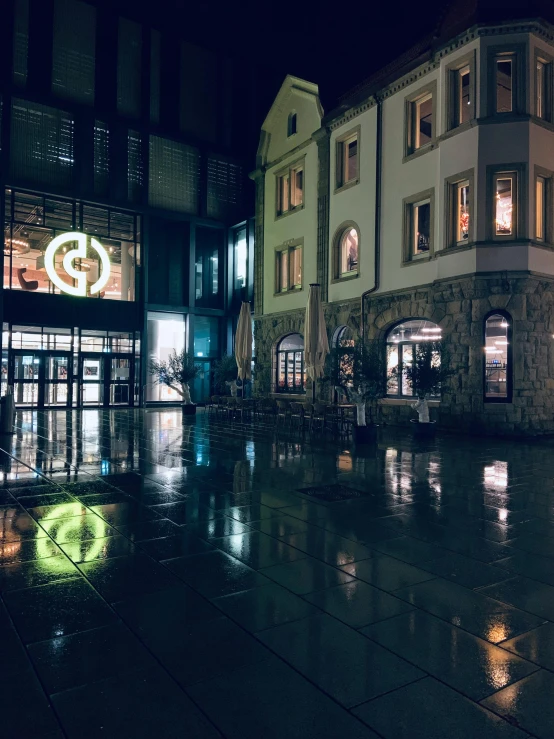 the buildings are all along the walkway at night