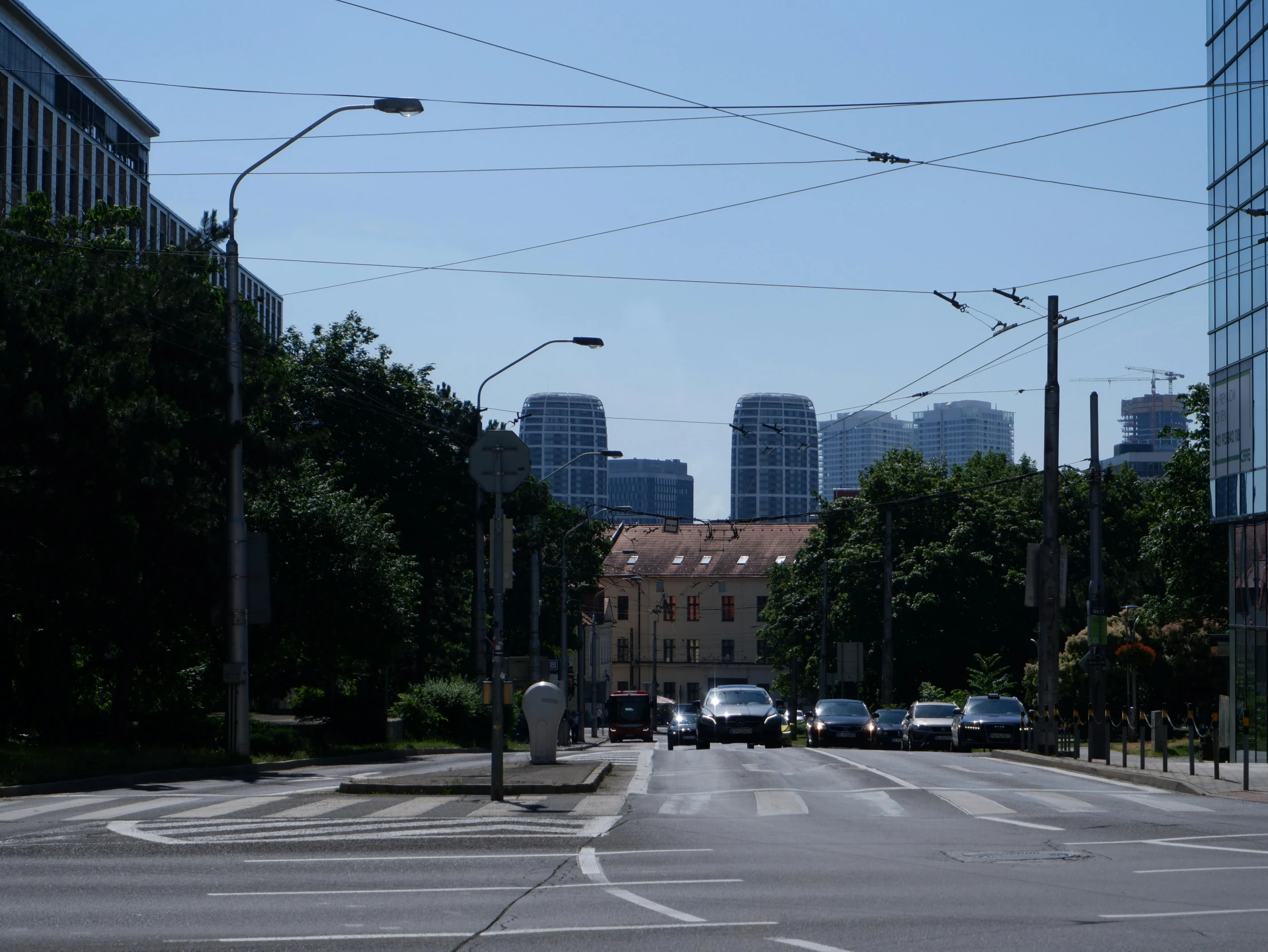 cars are driving down a street near an intersection