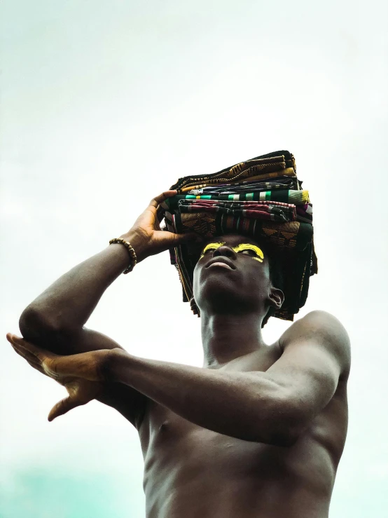 a man with  standing while holding soing in his head