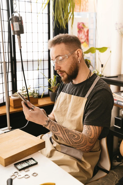 a man using a phone while he looks at soing