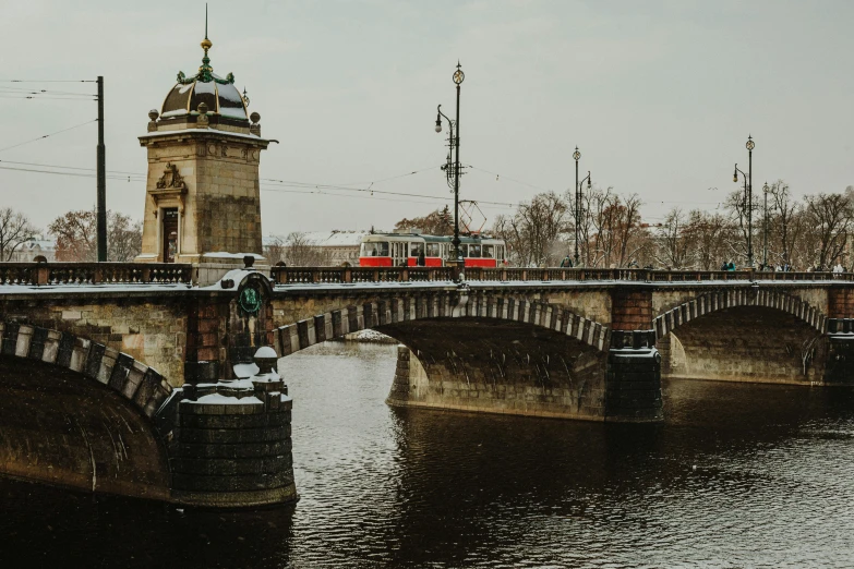 a large stone bridge with a tower on it