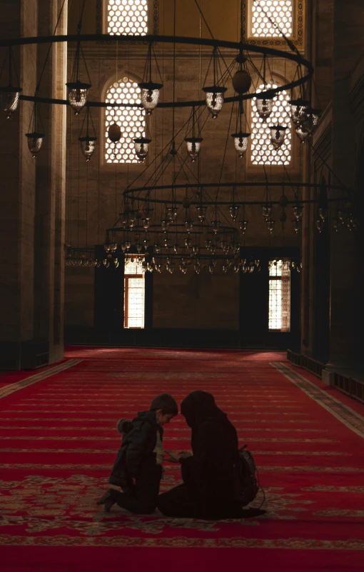 two people kneeling down to kiss on the ground