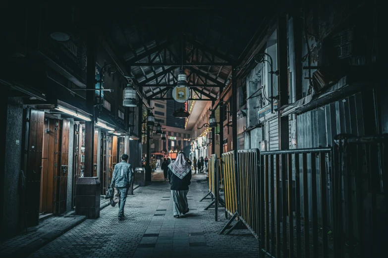 a couple of people walking down a tunnel