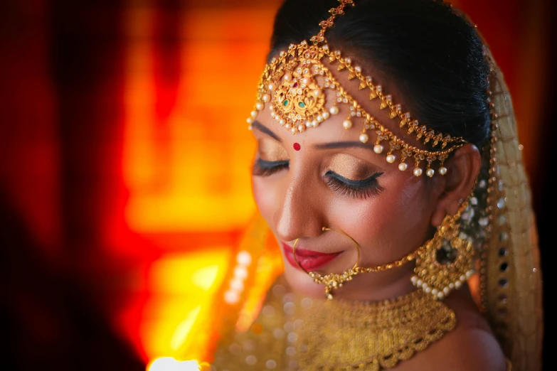 a beautiful indian bride in bridal look with a veil