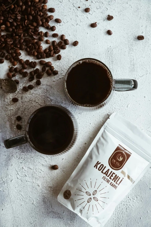 a bag of coffee sits next to a cup of coffee on a table