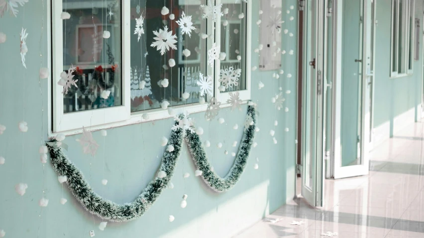 the front door of a building with snow flakes falling from the window