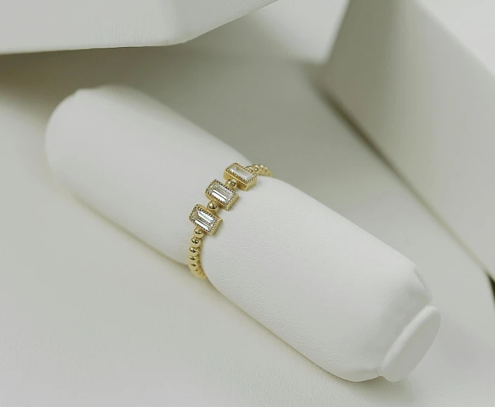 a ring sits on a white cloth