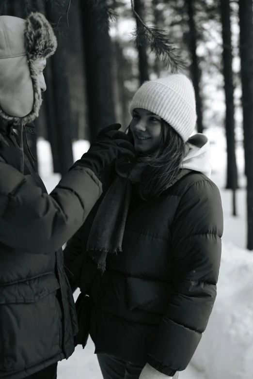 two women standing next to each other in the snow