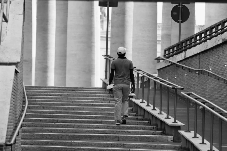 a man who is walking up some stairs