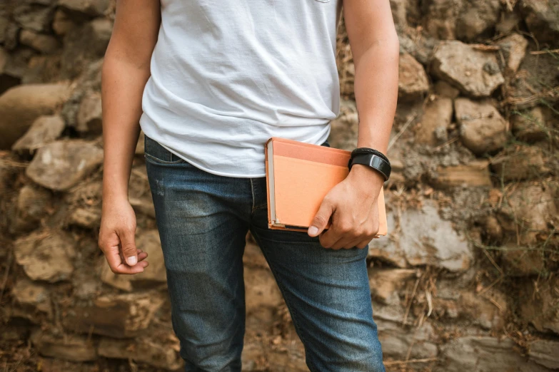 a man holding an open leather folder on his left hand