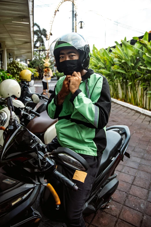 the guy is sitting on a motorcycle and posing for the camera