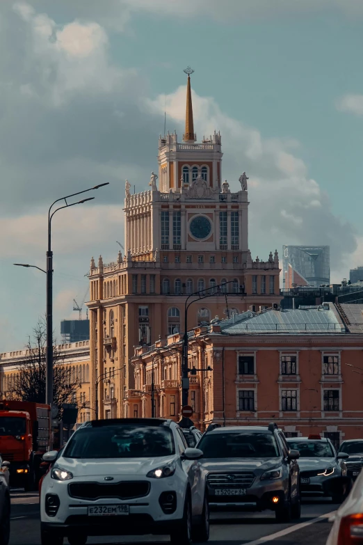 cars drive down a busy road in front of a church