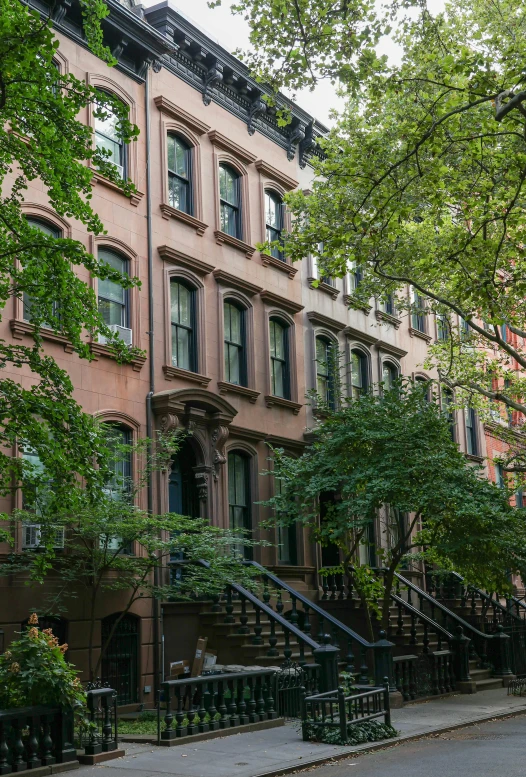 row houses on an old city street with trees and flowers