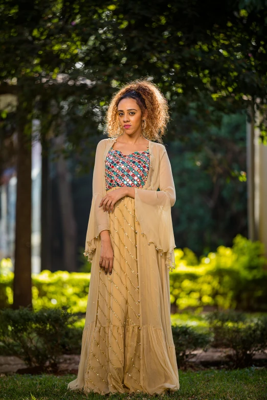 a woman in a brown and gold long dress