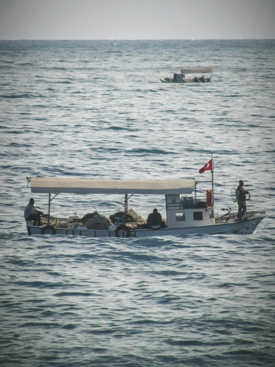 two fishing boats and a flag in the water