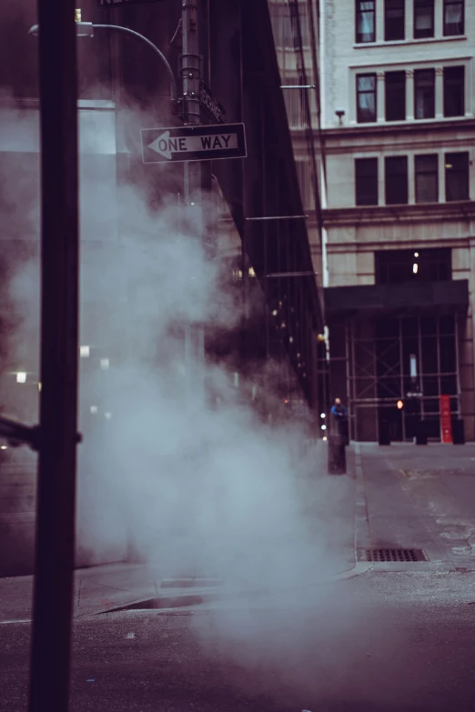 smoke and steam on a city street at night